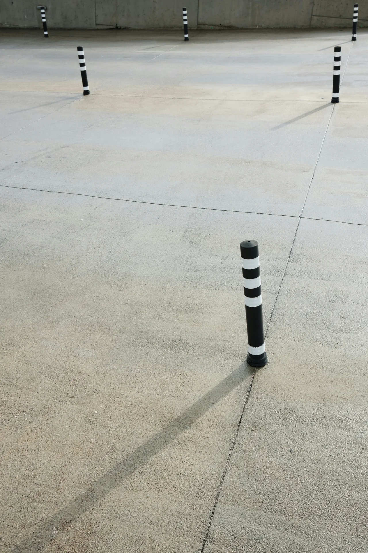 broom-finished concrete parking lot with bollards in Detroit