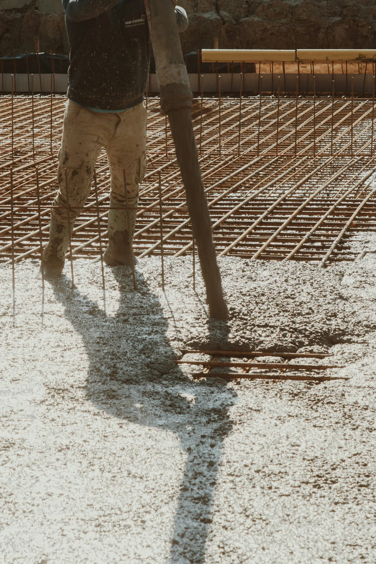 concrete pump hose placing concrete over a Detroit rebar mat