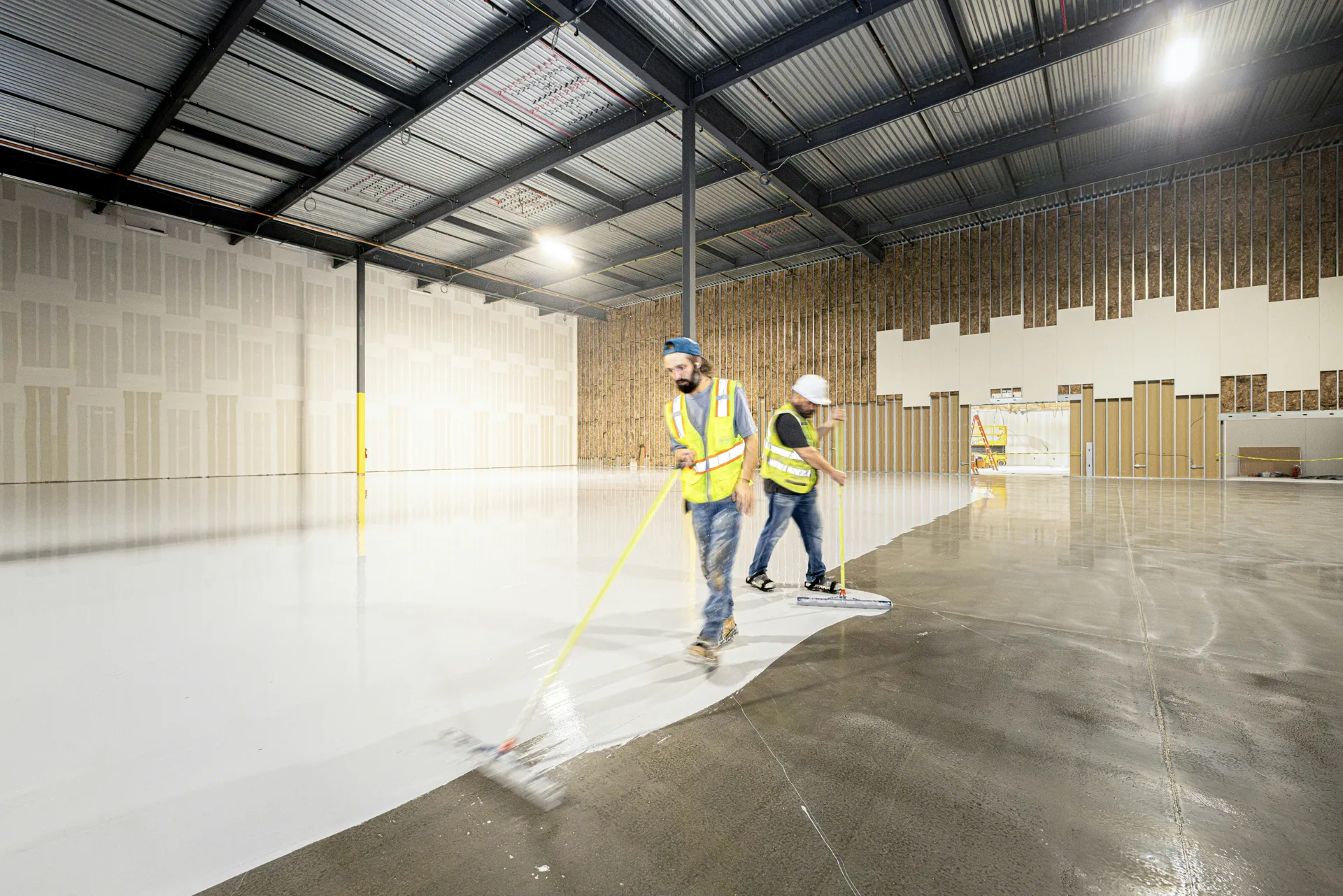 crew rolling epoxy onto a Detroit garage floor