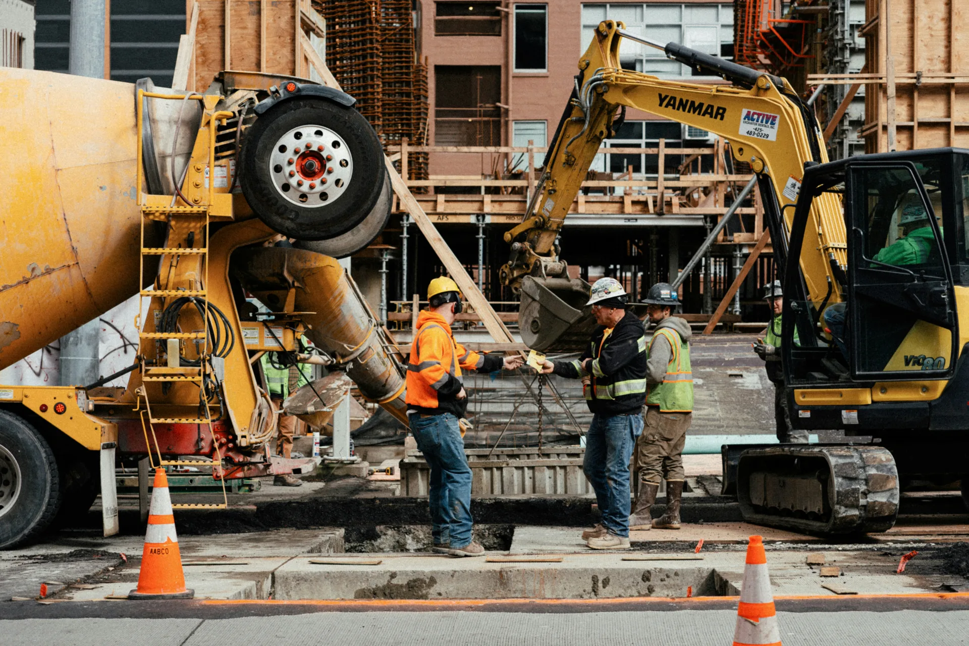 ready mix concrete pour on a Detroit urban site with a mini excavator
