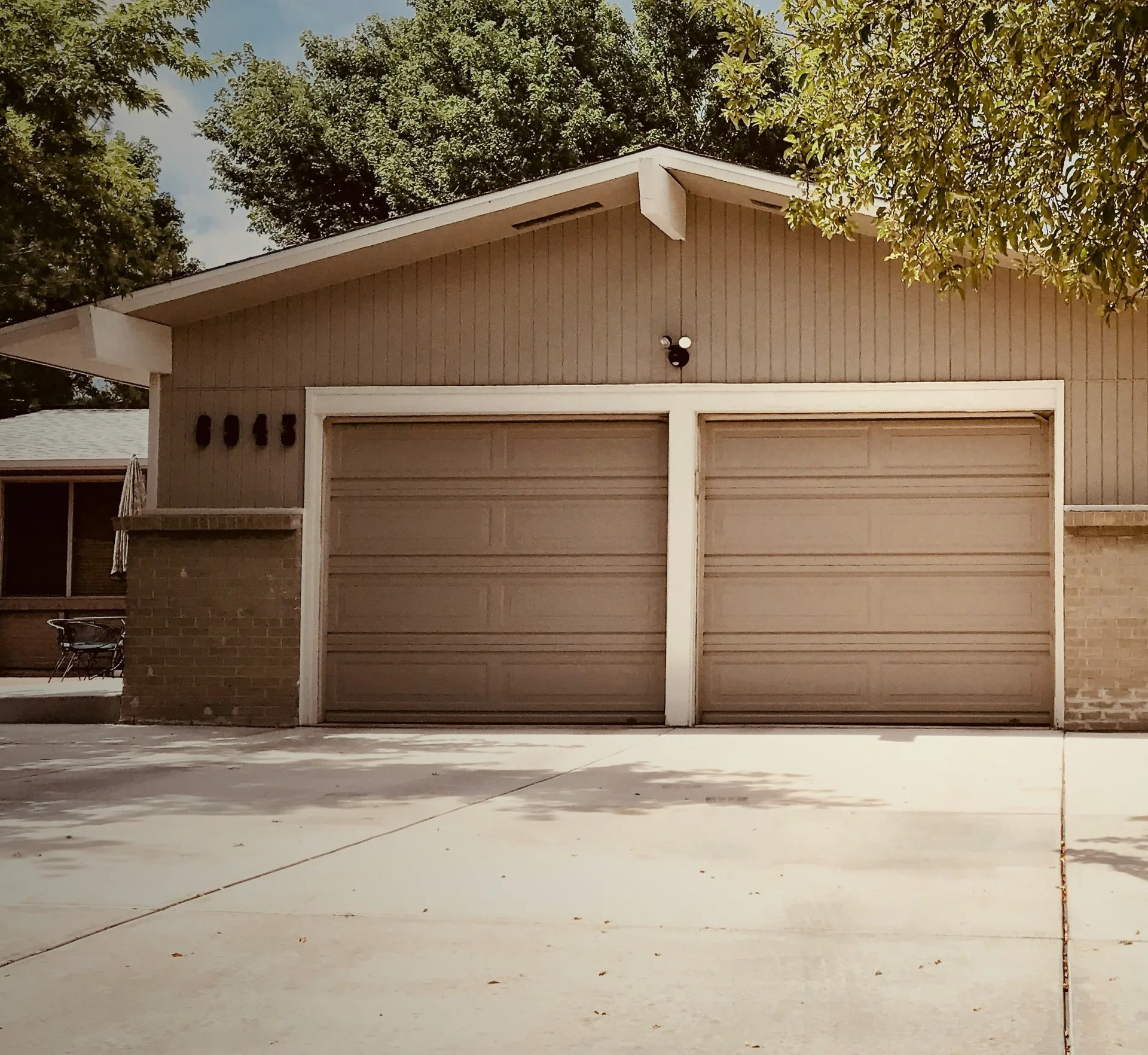 concrete driveway at a ranch home with a double garage in Detroit