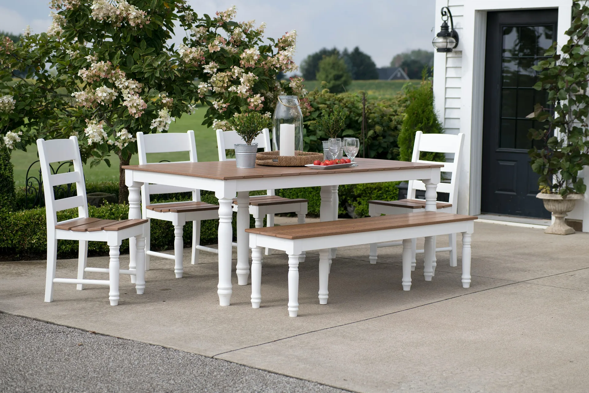 concrete patio with a dining table at a Detroit farmhouse