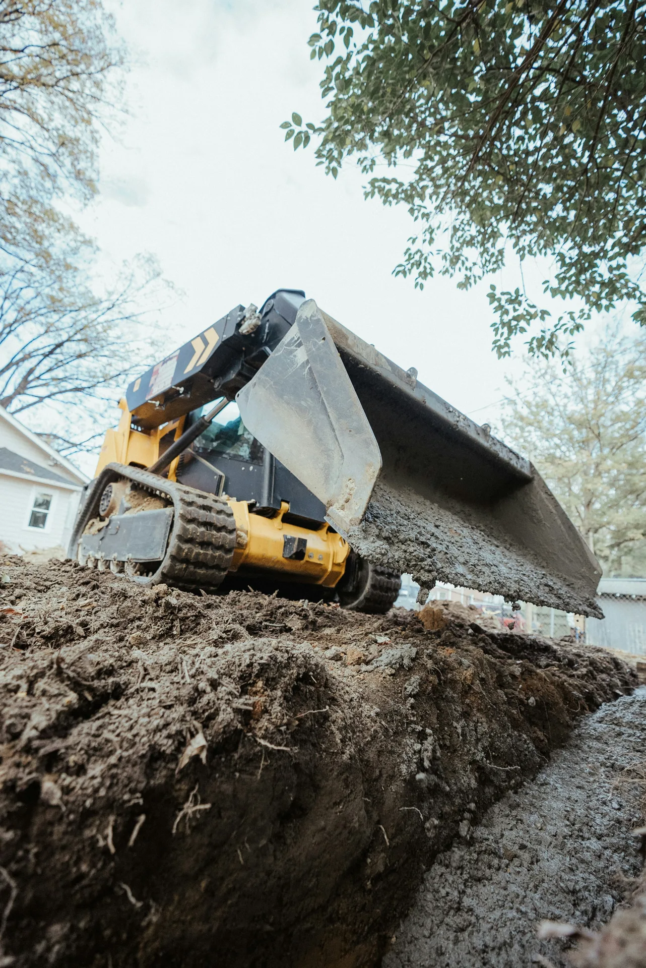 foundation repair pour with a track loader in Detroit