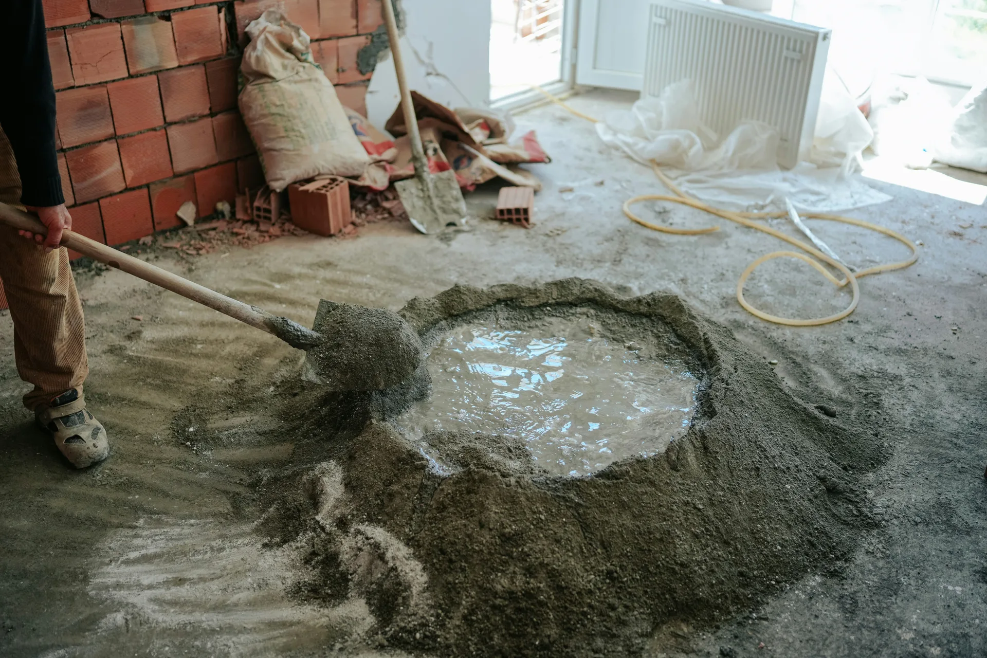 Mapei self-leveling compound being mixed on a Detroit renovation site