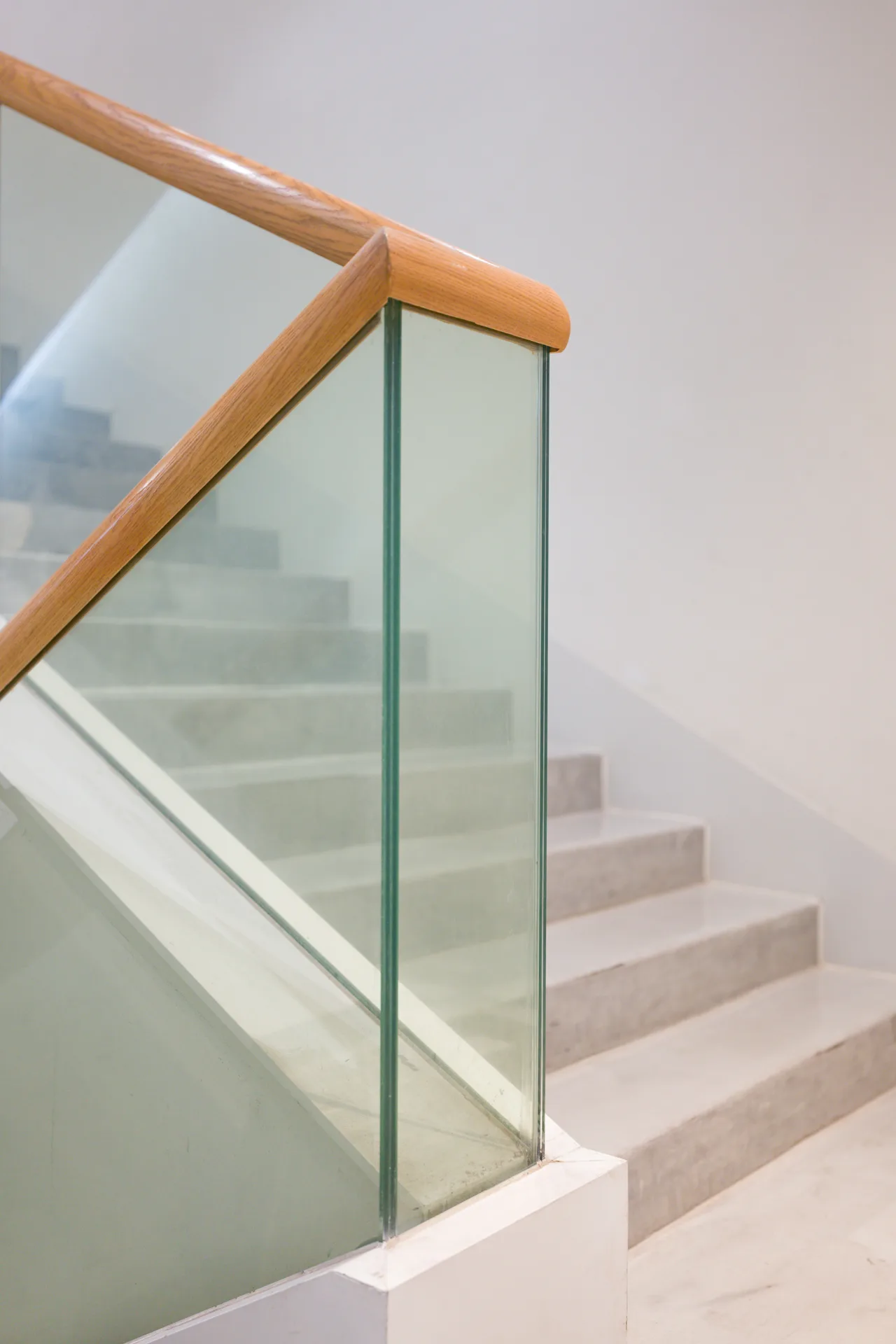 poured concrete staircase with glass railing at a Detroit home
