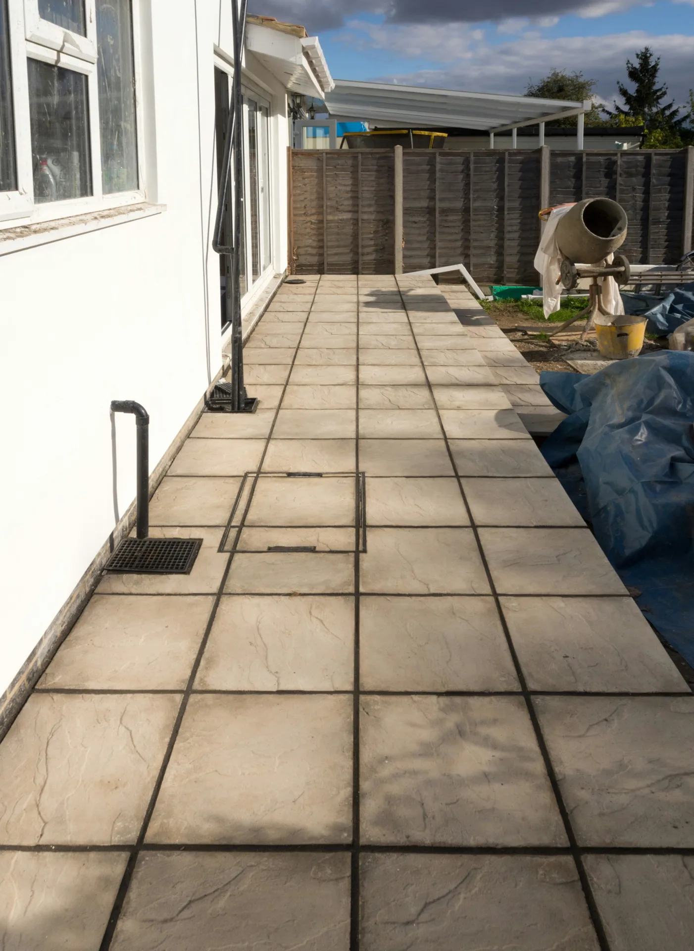 concrete walkway installation along the side yard of a Detroit home